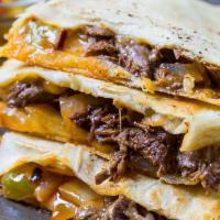 Philly Steak Quesadilla · Grilled  tortilla and topped with cheese and philly steak filling! Comes with sour Ceam and ...