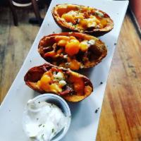 Potato Skins · Loaded with cheddar & blue cheeses,  sour cream, and bacon. Served with a side of sour cream.