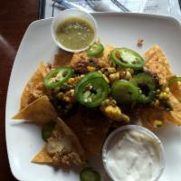 Chili Nachos with Ground Beef · Homemade chili with Ground Beef,  house made corn tortilla chips, cheddar cheese, pickled ja...