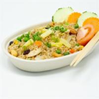 Pineapple Fried Rice · Stir-fried rice with scallions, tomatoes, carrots, raisins, cashew nuts, pineapples, and egg.
