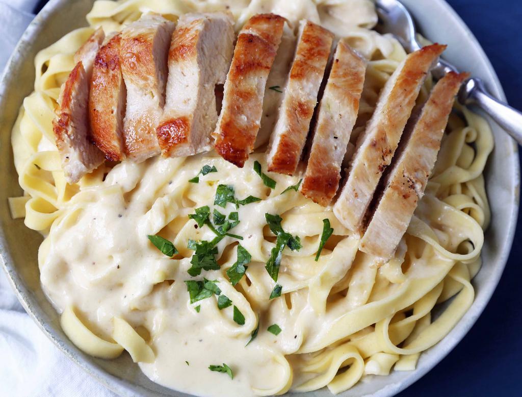 Chicken Fettuccine Alfredo Pasta  · Our Secret recipe Alfredo  Sauce,  With Freshly Made Fettuccine  sauteed Broccoli & Mushrooms, Grilled Chicken And Topped Off With  Parmesan Cheese . Served With A Side Of Garlic Bread