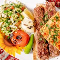 Halal Lamb Kebab Plate · Made with ( 2 skewers  lamb kebab ) and Comes with 3 sides.(hummus, rice, salad) and pita br...