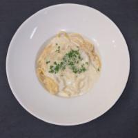 Fettuccine Alfredo · Creamy Alfredo sauce over pasta and topped with fresh Parmesan cheese. Add chicken or roaste...