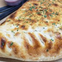Calzone · mozzarella and ricotta cheese folded inside of pizza dough with parsley dressing