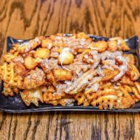 Poutine  · Waffle fries topped with cheese curds and gravy.