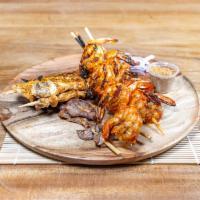 Kyinkyinga Skewers · 3 skewers grilled seasoned with our signature suya spice seasoning, comes with onions, tomat...