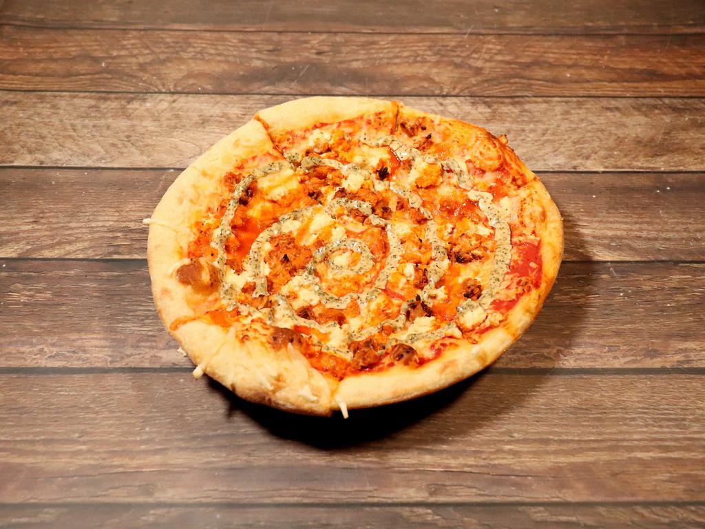 Buffalo Pizza · Red sauce, vegan cheese, buffalo cauliflower, almond ricotta dollops, ranch drizzle and chives.