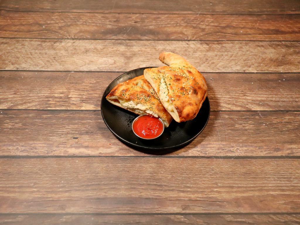 Cheese Calzone · Vegan cheese, ricotta and red sauce. Add fillings for an additional charge.