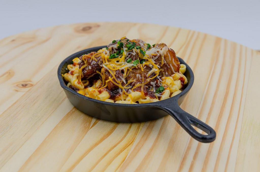 Burnt Ends Brisket Mac 'N' Cheese Aka Bucket O'Niell · Queso, mixed Cheddar, smoked brisket, BBQ sauce. Creamy, gooey mac served in a 6” ‘cast iron pan’ just like back on the trail.