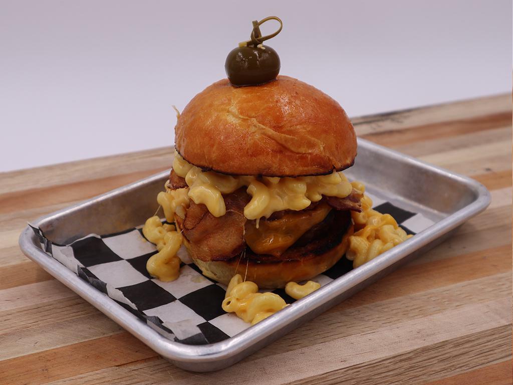 Bacon Mac Burger Aka Wyatt Earp · 1/2 lb beef patty, bacon, mac & cheese, brioche bun. Our chefs famous burgers! Every patty is seasoned and marinated to perfection, then sous vide!