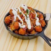 Loaded Tots · Sweet potato tots, sour cream, green onions, bacon, cheese. 