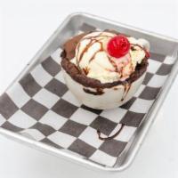 Brownie · Served with whipped cream and drizzled with chocolate sauce.