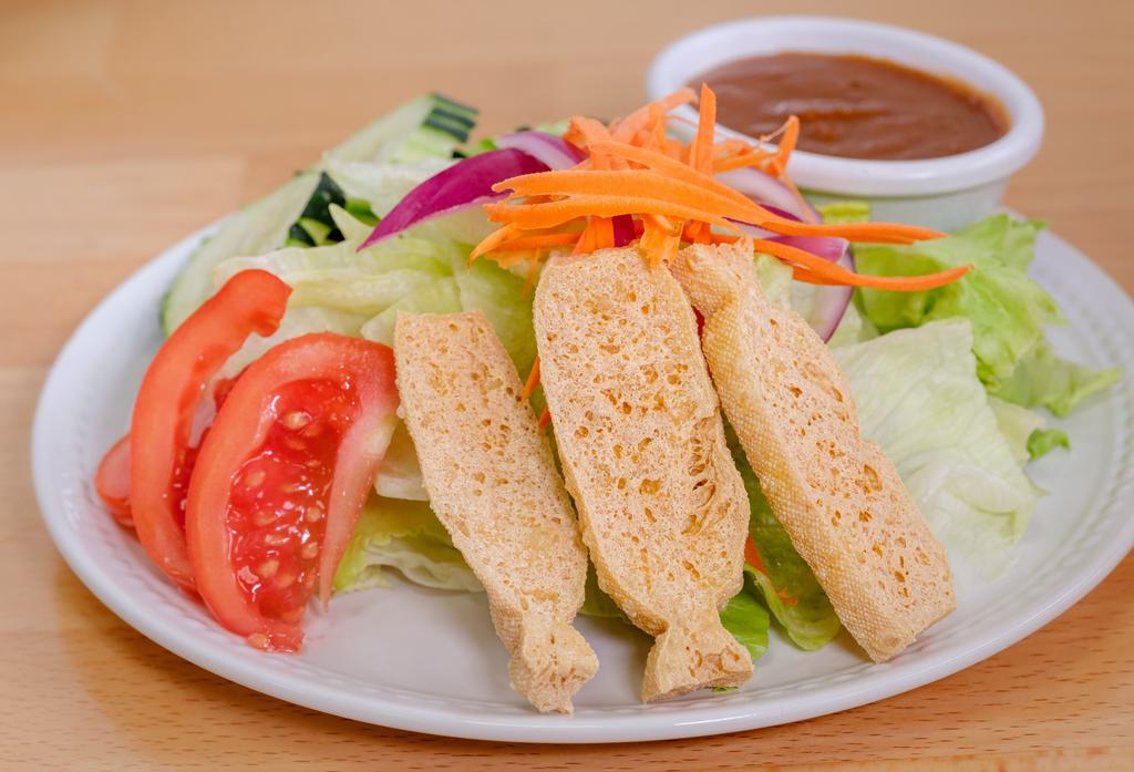 Salad Keak · Mixed green, carrot, cucumber, red onion, tomato, fried tofu served with peanut dressing.