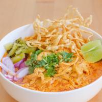 Khao Soi · Northern Thai styled curry noodle soup with chicken, red onion, cilantro, dried chili and cr...