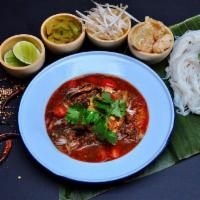 Ma Kin Khanom Jeen Nam Ngiaw · Northern of Thai. Chiang Mai style noodles with spicy pork and herbs served with fresh veget...