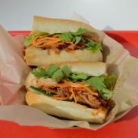 Pulled Pork Sandwich · Pulled pork with a spiced honey glaze. Toasted baguette, pickled carrots and daikon, jalapeñ...