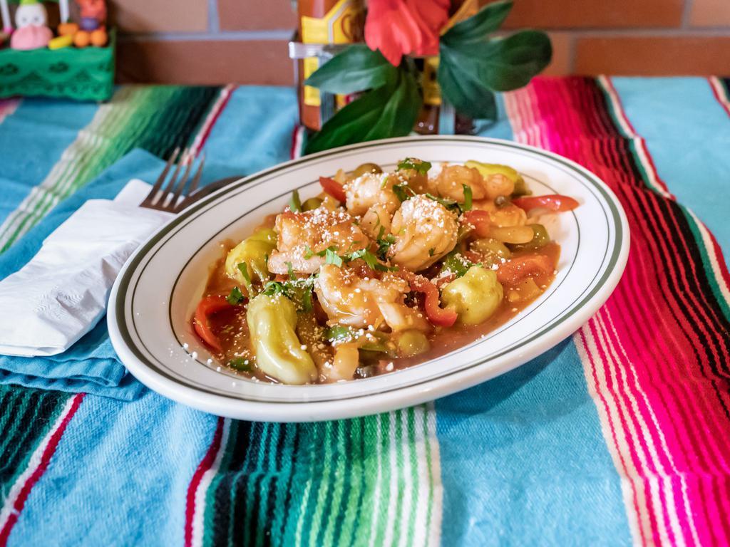 Camarones a la Veracruzana · Sauteed shrimps, peppers, olives, and capers in mild tomato sauce served with Mexican rice and tortillas.