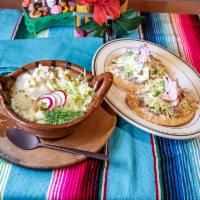 Pozole · Fresh white hominy corn with shredded pork in broth served with 2 pieces of tostadas.