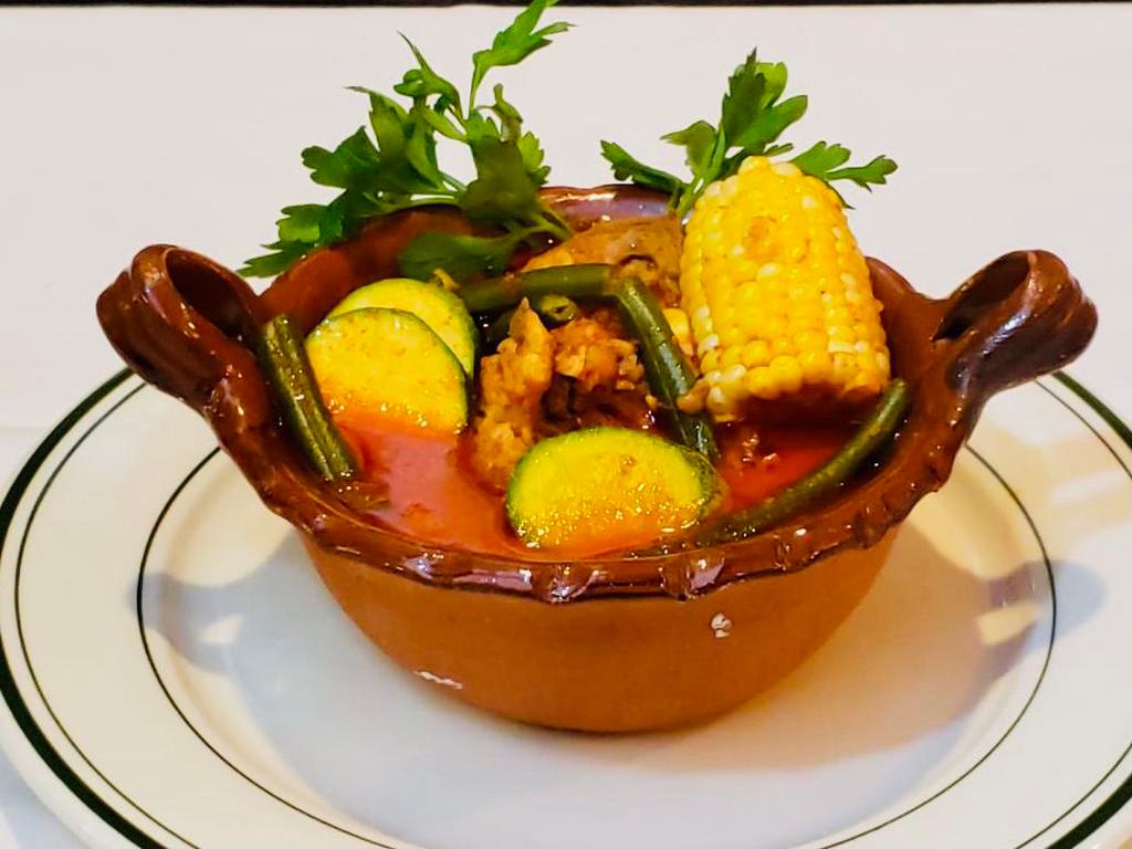 Mole de Olla · Beef short ribs, cilantro macho corn and carrots in a spiced broth served with corn tortillas.