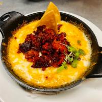 Queso Fundido · Melted Monterey Jack cheese topped with pico de gallo, sour cream, and chorizo or mushroom s...