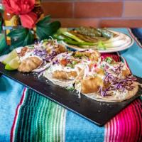 Pescado Taco · Deep-fried battered tilapia on a bed of sour cream topped with fresh cabbage, pico de gallo,...