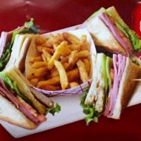 Club House Sandwich · Ham , cheese, bacon, tomato, lettuce, mayonnaise, French fries, and a drink.