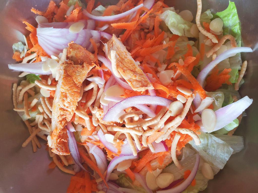 Asian Chicken Salad · Romaine lettuce, almonds, carrots, onions, orange, Asian noodles, grilled chicken and Chinese dressing.