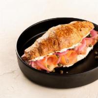 Lox Croissant · Croissant, roasted garlic cream cheese, sliced lox, pickled onion, capers.