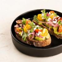 Avocado Toast · Sourdough bread, guacamole, pickled onions, tricolor cherry tomatoes, sheep feta cheese, aru...