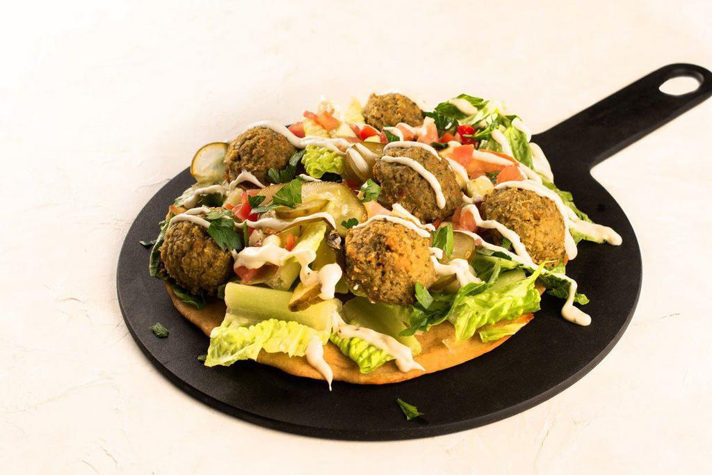 Falafel Salad Pizza · Gluten free crust, romaine lettuce, israeli salad, sour pickles, RR falafel balls, tahini drizzle.