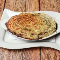 Shepherd's Pie · Ground beef simmered in brown gravy, carrots, peas topped with mashed potatoes then baked.