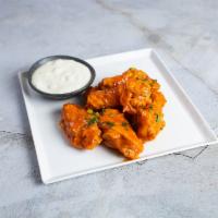 Buffalo Chicken Wings · Our homemade crispy chicken wings are a crowd favorite. Served with blue cheese. Six pieces.