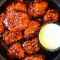 Boneless Wings  · Tossed in your choice of Nashville Hot Honey sauce served with celery, carrots and a side of...