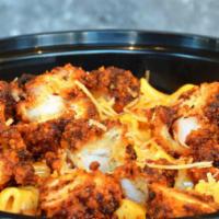 Nashville Hot Mac ’n Cheese · Creamy cheddar mac and cheese topped with crispy Nashville chicken tenders,  roasted green c...