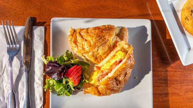 The Boss Egg Sandwich · 2 farm fresh eggs on a  toasted butter croissant with bacon, ham, tomato, white cheddar cheese.