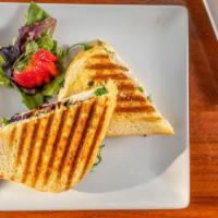 Grilled Chicken Panini · Sliced grilled chicken, feta cheese, arugula, balsamic glaze on lightly buttered panini bread.