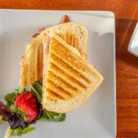 Ham & Cheddar Panini · Baked ham, cheddar cheese, chipotle mayo on lightly buttered panini bread.
