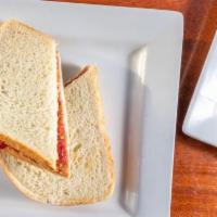 PB & J Sandwich · Creamy peanut butter and jelly (choice of grape or strawberry) on white bread.