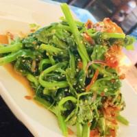Pea Shoot Salad · Green Pea Shoots tossed with tomatoes, red onions, sesame seeds, fried garlic chips and home...
