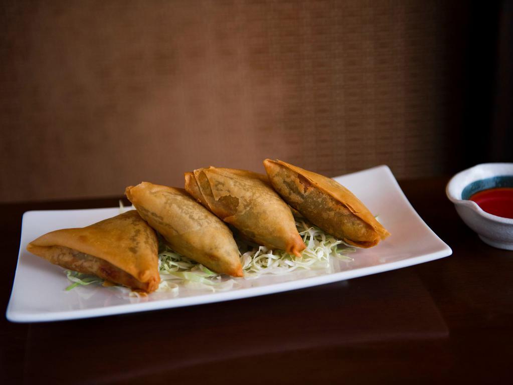 Vegetarian Samosas · Flour wrap with potatoes and peas mixed with Burmese spices. (4 pcs) - Cannot be made vegan or gluten free