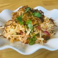Burmese Style Papaya Salad · Shredded fresh papaya tossed with cabbage, fresh red onions, cilantros, crushed red chili an...