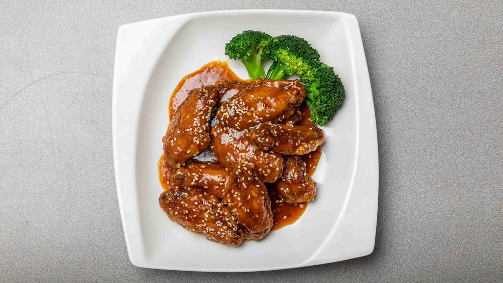 Honey Chicken Wings · Deep fried breaded chicken wings tossed in honey soy sauce, ginger, garlic, dried chili, sweet chili and sesame seeds.