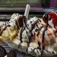 Triple Banana Split · 2 bananas and 3 scoops, whipped cream and chocolate drizzle.