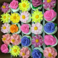 Regular Cupcakes · Cupcakes with white buttercream frosting, decorated with buttercream flowers in seasonal col...