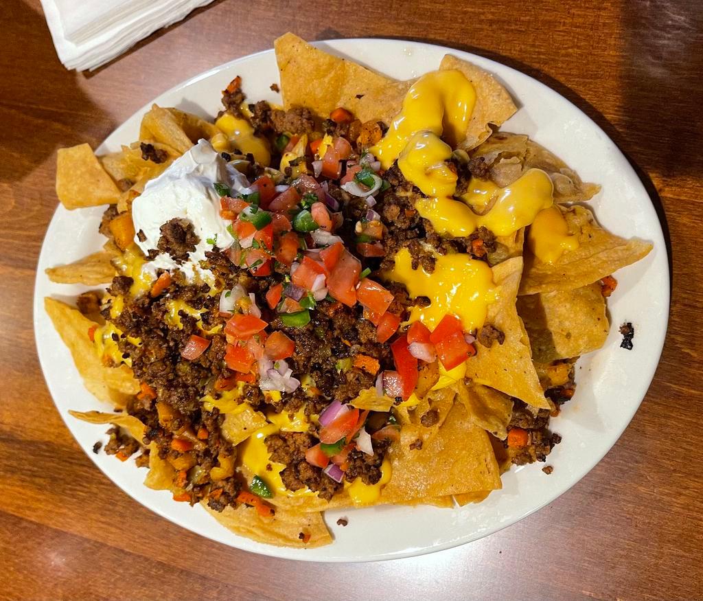 Nachos with Meat · Tortilla chips with cheese,pico de Gallo sour cream, jalapenos and your choice of meat. Please indicate meat choice