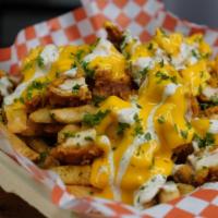 Nashville Fries · Our Crispy Nashville Chicken on top of garlic fries topped with our cheese sauce and house b...