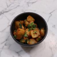 Batata Harra · Spicy crispy potatoes. garlic, lemon and coriander. Vegan.