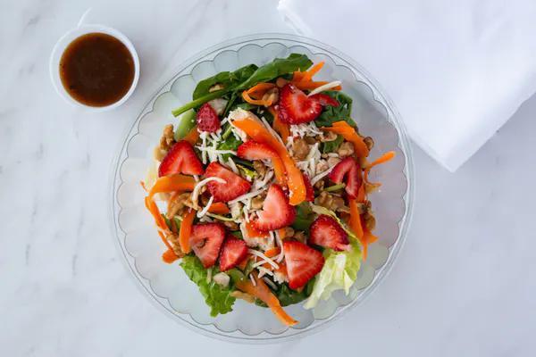 Strawberry Chicken Salad   ·  Romaine lettuce, spinach, grilled chicken strips, sliced strawberries, sliced carrots, walnuts, shredded mozzarella cheese and balsamic vinaigrette dressing.