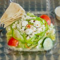 Greek Salad · A garden salad topped with feta cheese and black olives.