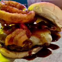 Cowboy Burger · Pepper jack cheese, bacon, onion rings, BBQ and toasted bun. 